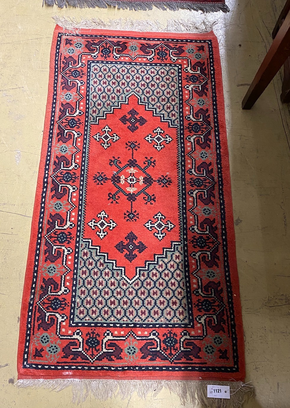 A Turkish red ground multi medallion rug, 137 x 72cm